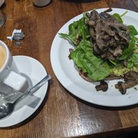 Decaffeinated Latte with Oat milk.
Sour dough toast served with smashed avocado, spinach, house made pesto, and mixed mushrooms. at Pimlico Fresh in South West London