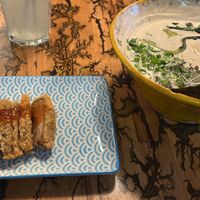 Mushrooms katsu ramen - there are chili flakes and sesame seeds on the table that I added to it  at Vegan AF Ramen in Krakow