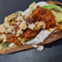 Toast with avocado, tahini, walnuts and sun-dried tomatoes. at Santa y Pura in Madrid