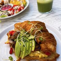 All-day breakfast croissant with tofu scram, roasted tomatoes and mushrooms, avocado + micro greens.   at Wildsprout in Western Cape
