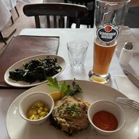 Aubergine with spinach and a glass of wheat beer  at Brenner in Munich