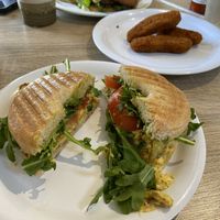 Just Egg breakfast sandwich (with tomato, loads of arugula) / plant-based chicken nuggets / Beyond Burger (with cheese, tomato, arugula, and grilled onion)  at Vine Cafe in New Bern
