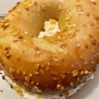 Peach schmear on onion bagel   at Ben & Esther's Vegan Jewish Deli in Portland