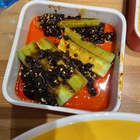 Partially eaten cucumber chili salad. It had a black bean paste.  at Noodle Master in Helsinki