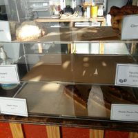 Various croissants, cinnamon bun, apple slice, and maple pecan pie; many sold out by midday. at The Well Bean Co in East London