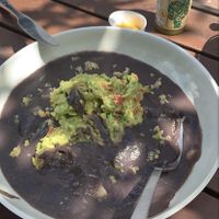 Enfrijoladas- tacos filled with quinoa, covered in a black bean sauce, topped with this amazing guacamole!  at The Pink Coconut in Cancun