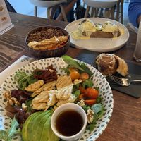 Pollo y aguacate with plant-based chicken, açaí bowl, vegan cinnamon roll, and the aguacate Benedict.   at Scarlett in Madrid