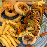 Black bean and chickpea hotdog with onion rings and fries at The Dirty Bottles in Alnwick