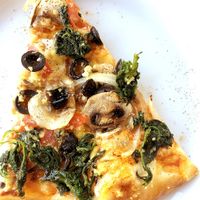 Vegan pizza: tomato sauce, vegan cheese, mushrooms, olives, onion, tomato, spinach and garlic at Martelli Pizza Italian in Paphos