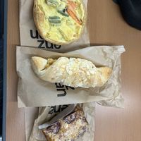 Vegetable „wähe“ (similar to a quiche), almond croissant, and plum cakee  at Enzian Vegane Bäckerei in Zurich