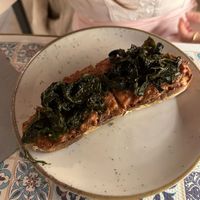 Bruschetta con crema di salsiccia e stracchetto con cavolo nero ripassato  at Status Quo in Rome