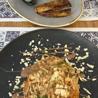Tagliatelle with hazelnut ragout and porcini mushrooms (bottom). Cordon Bleu of aubergines, smoked cheese, and porcini mushrooms (top).   at Status Quo in Rome