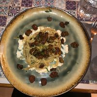 Spaghetti, ricotta di mandorle, melanzane e salsiccia   at Status Quo in Rome