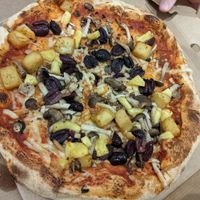 Build your own vegan pizza with kalamata olives, mixed mushrooms, pineapple and herbed potatoes at Pure Pizza in Edinburgh