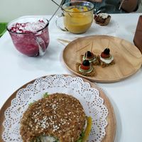 Burger with a bite out of it, beetroot and carrot soups and some tasters at Healthy Mania in Phuket