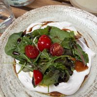Kaygana (chickpea pancake). Tasty but not enough of the cream cheese/salad for how dense the pancake was at The Garden Cafe & Restaurant in Budapest