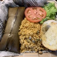 Pastel combo - Puerto Rican version of tamales, made out of plantains and stuffed with beyond meat. Comes with a side of yellow rice and pigeon peas. at 100% HP in San Juan