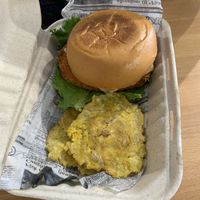 Spicy chicken sandwich with tostones (fried plantain) at 100% HP in San Juan