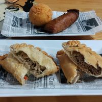 Empanadillas in front, relleno de papa and alcapurria behind at 100% HP in San Juan