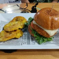 Spicy chikin burger with side of tostones at 100% HP in San Juan