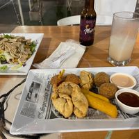 Conch + tostones on the left; HP sample platter at the bottom; soursop juice in the glass at 100% HP in San Juan