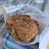 Half-eaten vegan burger  at KLIKKEAT in Carrara