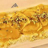 Ravioli ripieni ai ceci con emulsione di olio, limone, cannella e salvia croccante at Nativa in Rome