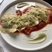 Ravioli filled with spinach in tomato sauce topped with vegan cheese  at Nativa in Rome