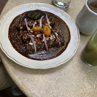 Plantain mole, spinach tamal, Verde enchiladas   at La Cabra Iluminada in San Miguel De Allende