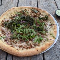 Pizza with dipping sauce at Vegan Pizza Bar in Rotterdam