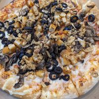 Custom vegan pizza with vegan chicken, mushrooms and black olives at Toppers Pizza in Indianapolis