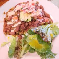 Under the beans and meat is plantains with cheese at Carmo in New Orleans