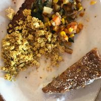 Pom platter-French toast w/ coconut cream, tofu scramble, potato hash, tempeh bacon at Pomegranate Cafe in Phoenix