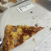 Thin crust, vegan flavor bomb sauce, onions, pineapple roasted tomatoes (no cheese)  at Infinitus Pie in Broomfield