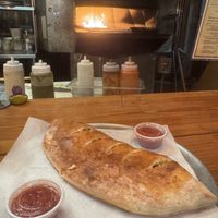 Spinach and mushroom vegan calzone  at Daytona Pizza & Wing Co in Daytona Beach