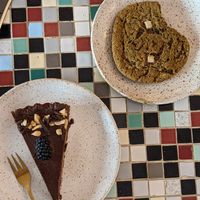 Chocolate caramel cake and matcha cookie at Eter Vegan Bakery in Warsaw