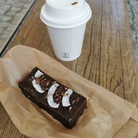 Coconut choco bar and cappuccino at Eter Vegan Bakery in Warsaw
