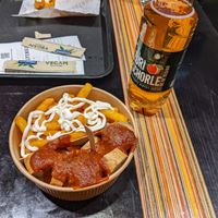 Currybanger with french fries. at UNMEAT in Zurich