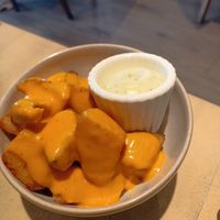 Roast Potatoes with a cheezy sauce and aioli dip 😋 at The Vibe in Liverpool