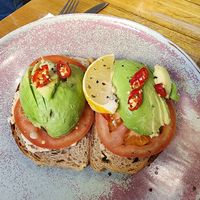 Toasted sourdough with hommus, chili, tomato and avo at Red Door Cafe  in Leura