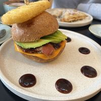 Photo ID: Vegan bacon and egg roll with hash brown and vegan cheese toast is in the background  at Swallow Coffee Traders in Rockdale