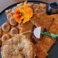 Incredibly delicious chicken with waffles. We got a bonus egg on the side and it was vile. at The Little Poet in Hobart