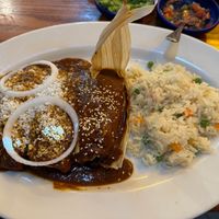 Vegan emplatanadas -- "Two enchiladas filled with plantains and cheese, topped with with mole, queso fresco and onions. Serviced with raise and a black beans tamal." at Salsa A La Salsa in Minneapolis