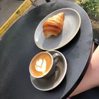 Oat flat white and a vegan croissant   at Colombia Coffee Roasters in Oxford