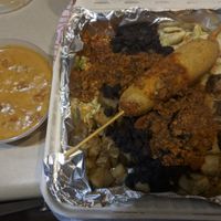 Not the greatest photo, but one of their recent vegan specials (a corn dog garbage plate!!!) and a side of their new vegan queso.  at John's Tex Mex in Rochester