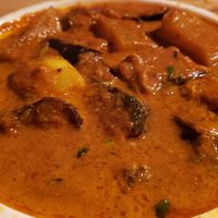 Aloo begun ($13). Acrid/bitter flavor, undercooked potatoes. at Curry In A Hurry in Minneapolis