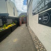 Entrance - tucked away (spot the flowers at the end of the pub on the corner) at Green Island Bistro in Rhuddlan