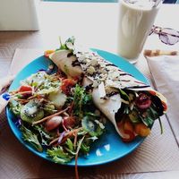 Vegan wrap includes side salad. Wrap contains beans, chick peas, avocado, mango, toasted nuts and seeds, capsicum, greens, balsamic glaze etc. Coffee date smoothie made on oat milk at O Meu Boteco in Monte Gordo