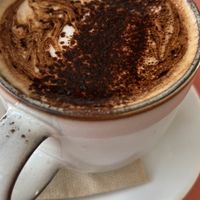 Cappuccino in a mug  at Sarah's Sisters in Semaphore