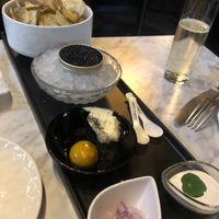 'Caviar' service with truffle chips, butter, (tomato) egg yolk, sour cream and red onions.   at 4296 in Canmore